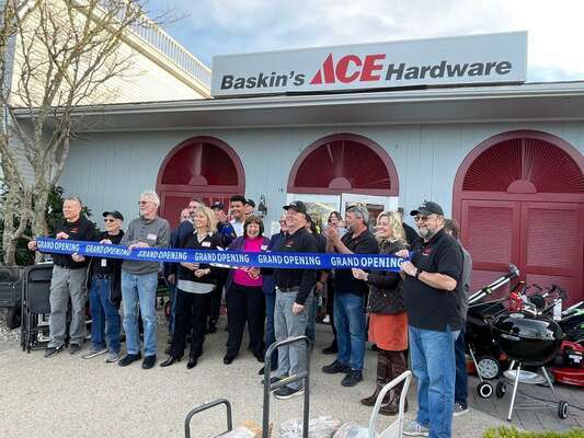 The Baskin’s ACE Hardware team gathers for a photo Monday night outside of their new location at 10 South Orleans Rd., the former home of the Christmas Tree Shop.