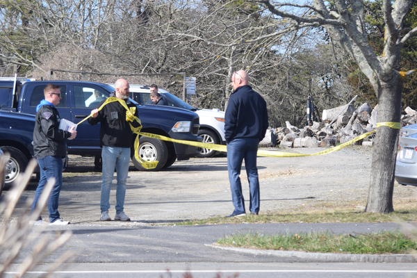 Investigators string crime scene tape around the property Monday afternoon.  TIM WOOD PHOTO