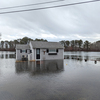 A home on North Road, West Harwich, was surrounded by water from the Herring River. The road was also covered for several hours. ALAN POLLOCK PHOTO