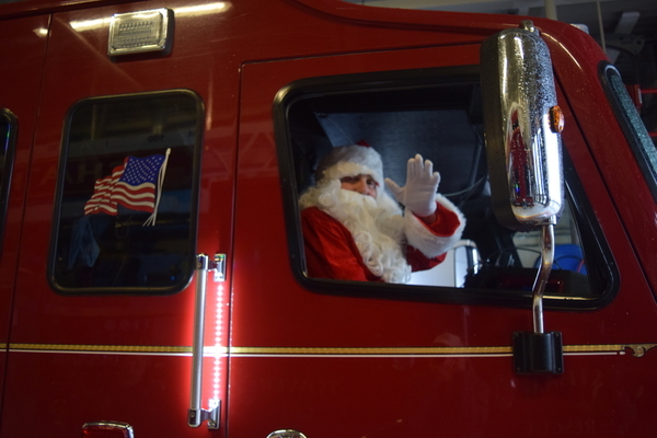 Santa hitches a ride in a Chatham fire engine. TIM WOOD PHOTOS