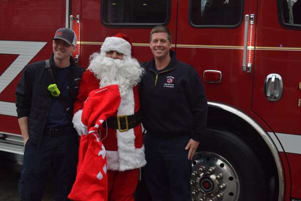 Santa stopped to say hello to Chatham Firefighters Tyle Baker, left, and Joe Bono.