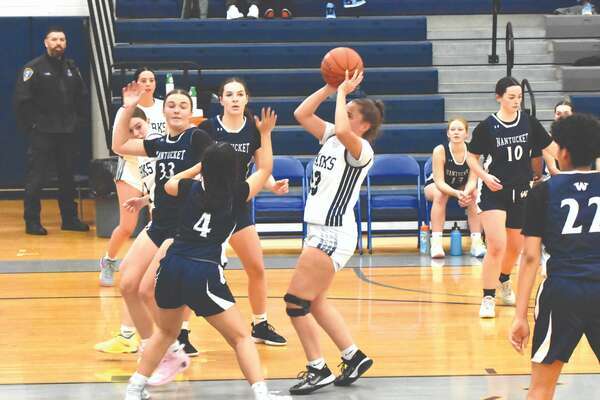 Monomoy junior Fiona Moore lets a shot from the middle of the lane against Nantucket.