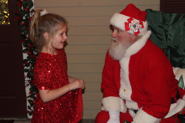Joanna Jenkins chats with Santa during the Christmas Stroll in Harwich Port on Friday evening.