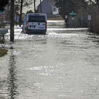 Vehicles braved the flooding on Morris Island Road. ALAN POLLOCK PHOTO