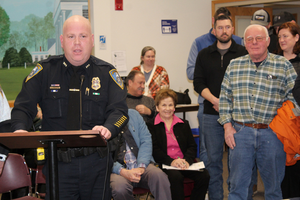 Deputy Police Chief Kevin Considine speaks during Monday's select board meeting where he was named the town's next police chief. Behind Considine is retired special police officer Robert Currie, a former teacher in the Franklin School System, who introduced Considine 
to policing in Harwich while the new chief was a student.
