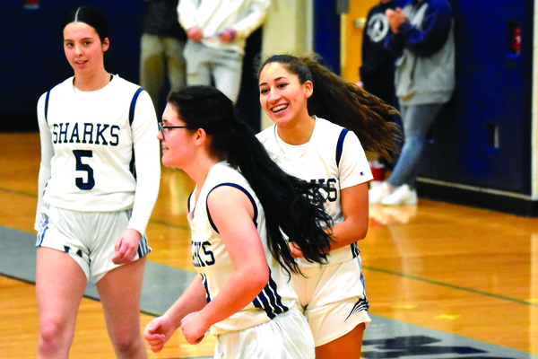 Monomoy senior Tatiana Malone, right, celebrates with classmate AJ Gates while sophomore Kiley Mawn (5) looks on after Gates made a basket during Friday’s lopsided win over Nantucket in Harwich. BRAD JOYAL PHOTOS