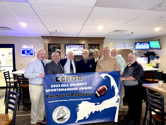Longtime Harwich resident Bill Doherty (fourth from left) recently learned that the Cape Cod Football Officials Association has named its sportsmanship award after him. CCFOA Commissioner Jim Butcher, far left, said it was “an easy choice” to name the award after Doherty, who began officiating local basketball games in 1966 before starting to officiate football games around 1970. COURTESY PHOTO