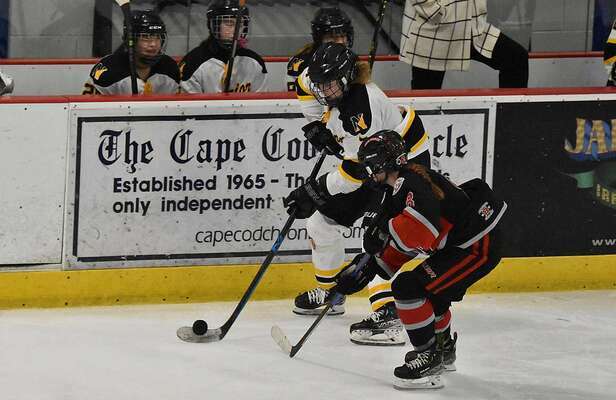 Nauset junior Carly Brand skates with the puck in front of the Warriors’ bench.
