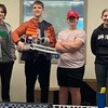 From left: The Monomoy robotics team of junior Josh Finkle, sophomore Tommy Chase, freshman Kade Stephens and eighth-grader Lilly Chase pose for a photo with their robot. The group will represent Monomoy during the school’s first-ever appearance at the Southern New England High School VRC Regional Championships on Feb. 26-27 in Bridgeport, Conn. COURTESY PHOTO