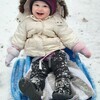 Eighteen-month-old Liberty Pike had her first sledding experience in Brewster Tuesday, as the region saw its first major snowfall in almost two years. REBECCA PIKE PHOTO