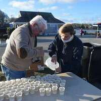 LCOC board member George Malloy and volunteer Eva Orman prepared water for the finishers.