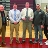 From left: Cape Cod Tech athletic director Alan Harrison, junior varsity coach Kevin Furey, varsity coach Brent Warren, freshman coach Alex Riker and athletic trainer Holly Mastronardi pose for a photo after presenting Warren with a plaque commemorating his 20-year coaching career before the team’s final game of the season. BRAD JOYAL PHOTOS