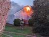 Crews attack a fire that quickly moved through a house in North Chatham Tuesday afternoon. ALAN POLLOCK PHOTOS