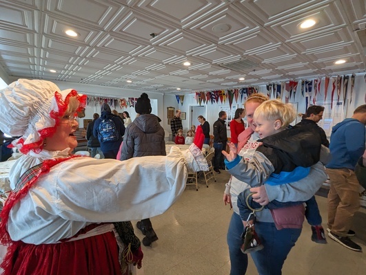 Two-year-old Nolan Connelly gives a high-five to Mrs. Claus.