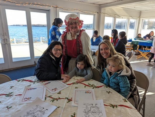 Mrs. Claus visits with young Haddie (left) and Callie Rotti at Saturday’s breakfast at the Orleans Yacht Club. ALAN POLLOCK PHOTOS